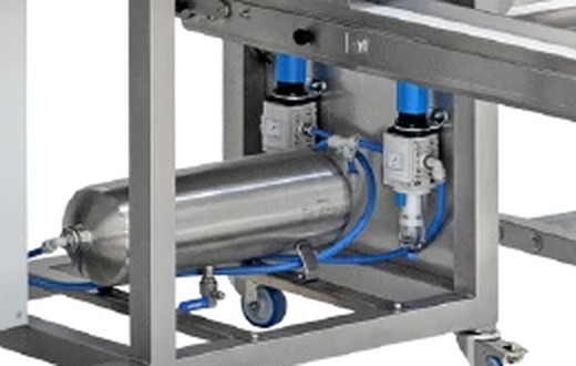 Close view under the machine: a horizontal steel air tank with two regulators above it, each with a blue knob on top.