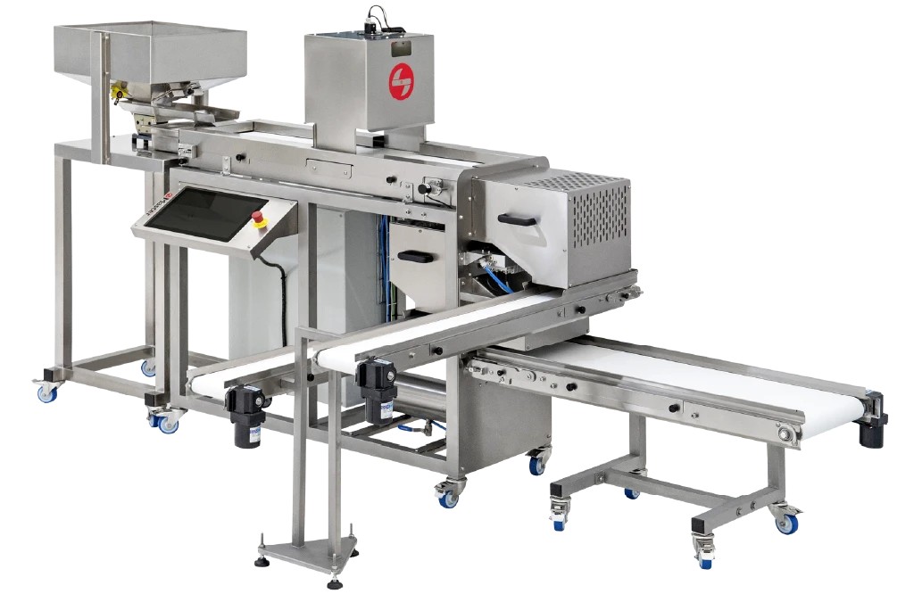 The Ai Sorter: a stainless steel machine with a feed hopper on the left, a camera hood above the belt, a touchscreen at the front and output conveyors leading away.