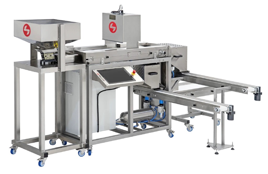 The sorter seen from the infeed end, with the hopper in front, the camera hood behind it and the output conveyors leading away to the right.